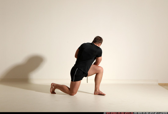 Man Adult Muscular White Fighting with sword Kneeling poses Sportswear