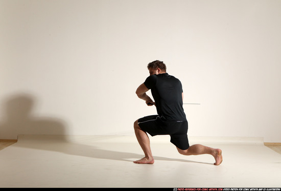 Man Adult Muscular White Fighting with sword Kneeling poses Sportswear