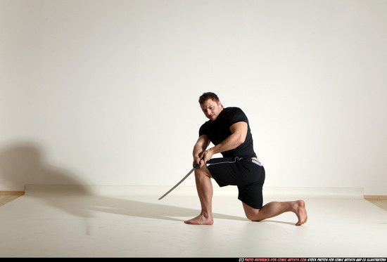 Man Adult Muscular White Fighting with sword Kneeling poses Sportswear