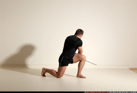 Man Adult Muscular White Fighting with sword Kneeling poses Sportswear