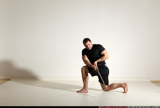 Man Adult Muscular White Fighting with sword Kneeling poses Sportswear