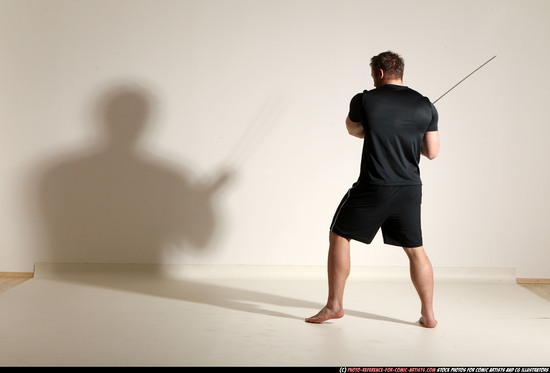 Man Adult Muscular White Fighting with sword Kneeling poses Sportswear