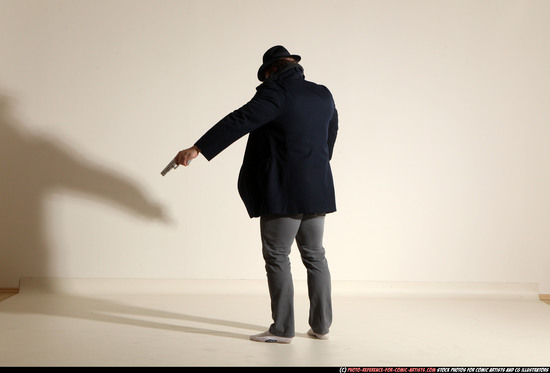 Man Adult Muscular White Fighting with gun Standing poses Coat