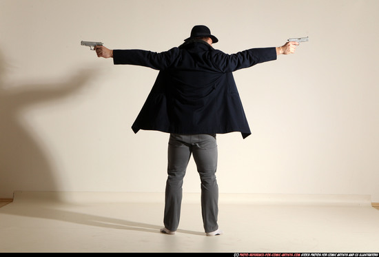 Man Adult Muscular White Fighting with gun Standing poses Coat