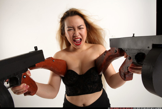 Woman Young Average Fighting with submachine gun Standing poses Asian
