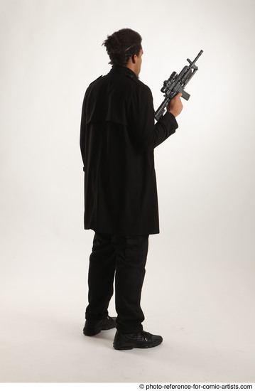 Man Adult Average Black Fighting with gun Standing poses Coat