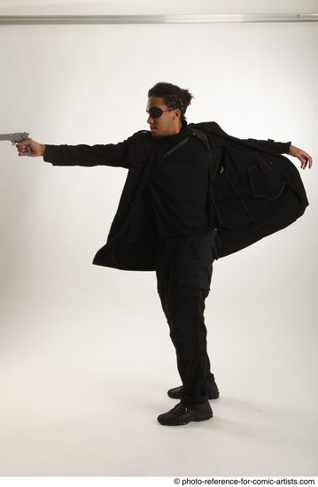 Man Adult Average Black Fighting with gun Standing poses Coat