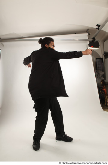 Man Adult Average Black Fighting with gun Standing poses Coat