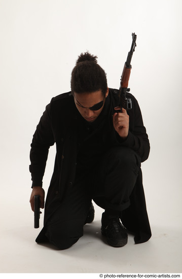 Man Adult Average Black Fighting with gun Sitting poses Coat