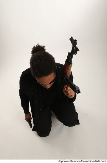 Man Adult Average Black Fighting with gun Sitting poses Coat