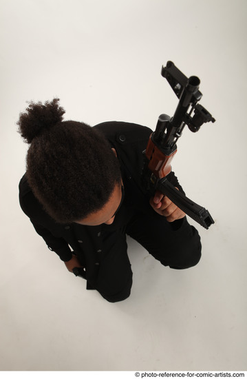 Man Adult Average Black Fighting with gun Sitting poses Coat