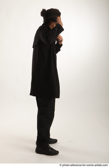 Man Adult Average Black Fighting with gun Standing poses Coat