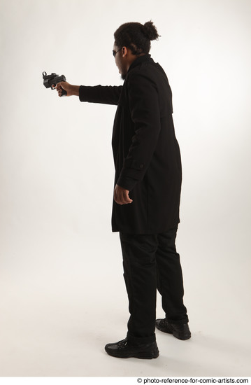 Man Adult Average Black Fighting with gun Standing poses Coat