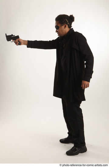 Man Adult Average Black Fighting with gun Standing poses Coat