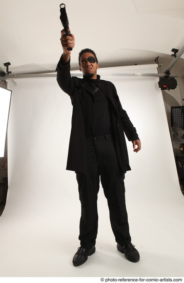 Man Adult Average Black Fighting with gun Standing poses Coat