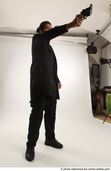 Man Adult Average Black Fighting with gun Standing poses Coat