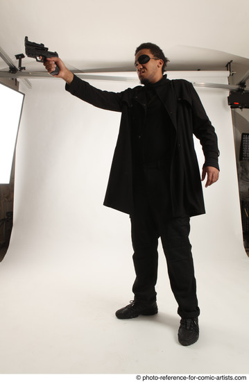 Man Adult Average Black Fighting with gun Standing poses Coat