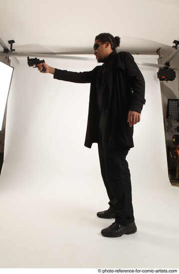 Man Adult Average Black Fighting with gun Standing poses Coat