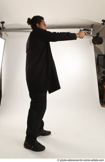 Man Adult Average Black Fighting with gun Standing poses Coat