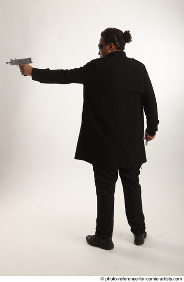 Man Adult Average Black Fighting with gun Standing poses Coat