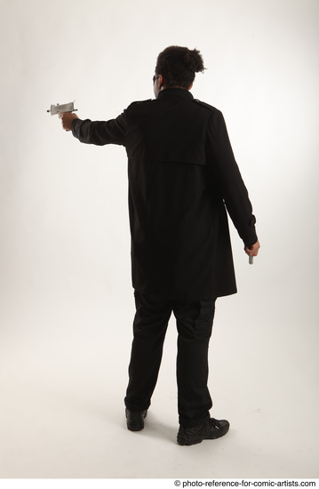 Man Adult Average Black Fighting with gun Standing poses Coat