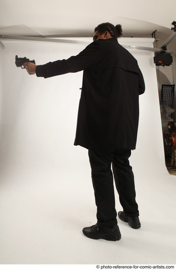 Man Adult Average Black Fighting with gun Standing poses Coat