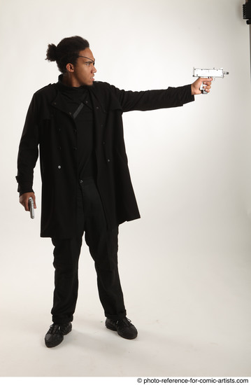 Man Adult Average Black Fighting with gun Standing poses Coat