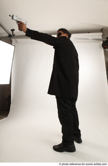 Man Adult Average Black Fighting with gun Standing poses Coat