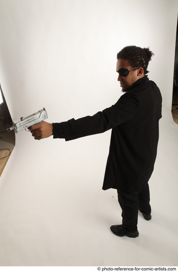 Man Adult Average Black Fighting with gun Standing poses Coat