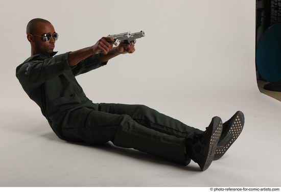 Man Adult Average Black Fighting with gun Sitting poses Casual