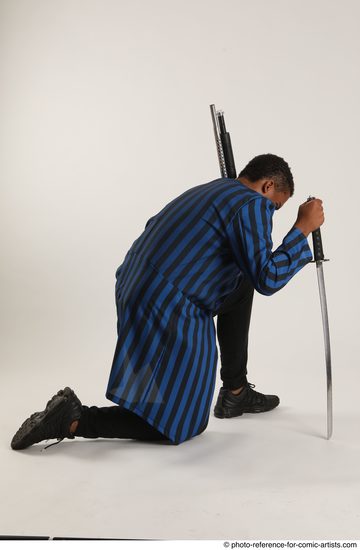 Man Adult Average Black Kneeling poses Casual Fighting with shotgun