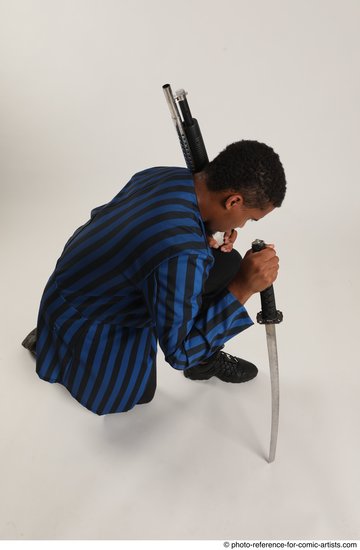 Man Adult Average Black Kneeling poses Casual Fighting with shotgun