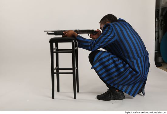 Man Adult Average Black Kneeling poses Casual Fighting with shotgun