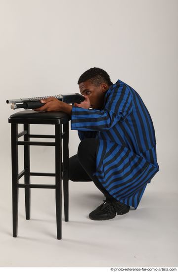 Man Adult Average Black Kneeling poses Casual Fighting with shotgun