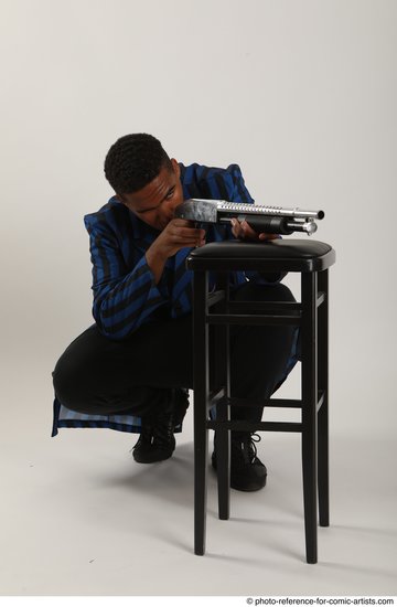 Man Adult Average Black Kneeling poses Casual Fighting with shotgun