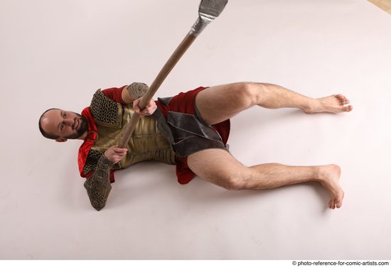 Man Adult Average White Fighting with spear Laying poses Casual