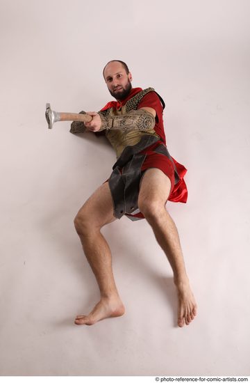 Man Adult Average White Fighting with spear Laying poses Casual