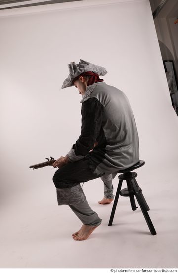 Man Adult Average White Fighting with gun Sitting poses Coat