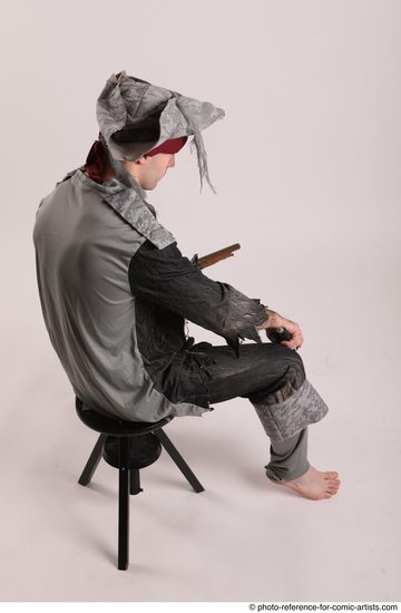 Man Adult Average White Fighting with gun Sitting poses Coat