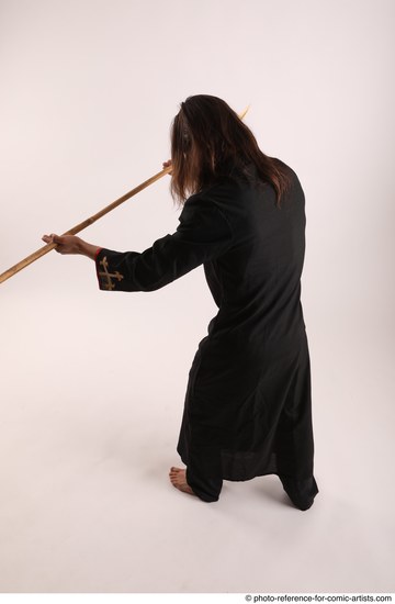 Man Adult Average White Fighting with spear Standing poses Coat