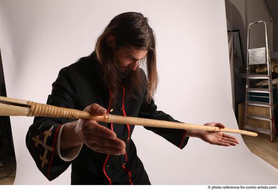 Man Adult Average White Fighting with spear Standing poses Coat