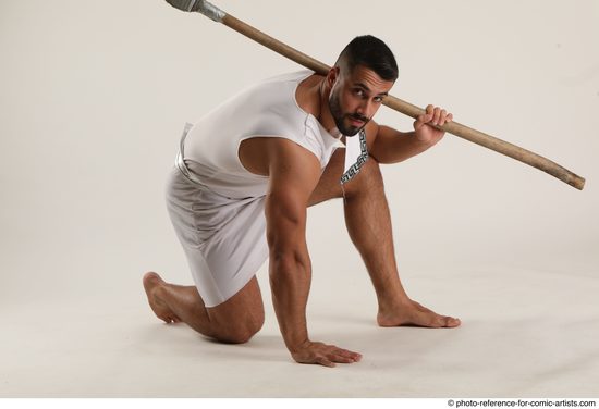 Man Adult Muscular Fighting with spear Kneeling poses Coat Latino