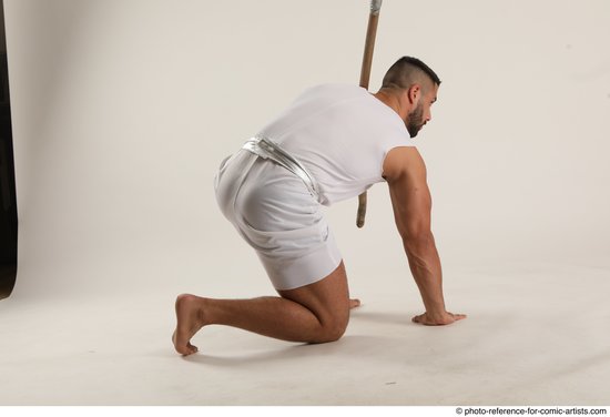 Man Adult Muscular Fighting with spear Kneeling poses Coat Latino