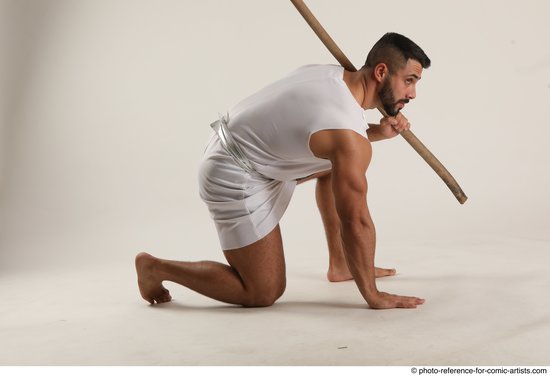 Man Adult Muscular Fighting with spear Kneeling poses Coat Latino