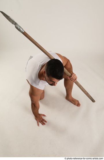 Man Adult Muscular Fighting with spear Kneeling poses Coat Latino