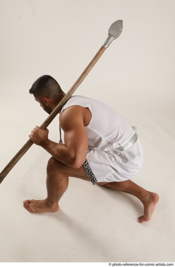 Man Adult Muscular Fighting with spear Kneeling poses Coat Latino