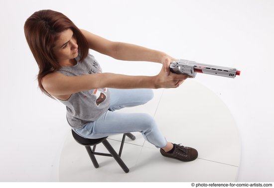 Woman Adult Athletic White Fighting without gun Sitting poses Casual