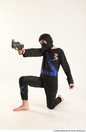 Man Young Athletic Fighting with gun Kneeling poses Casual Asian