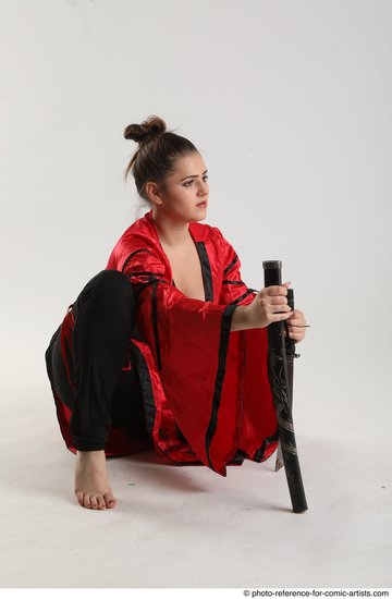 Woman Adult Average Fighting with knife Kneeling poses Coat Latino