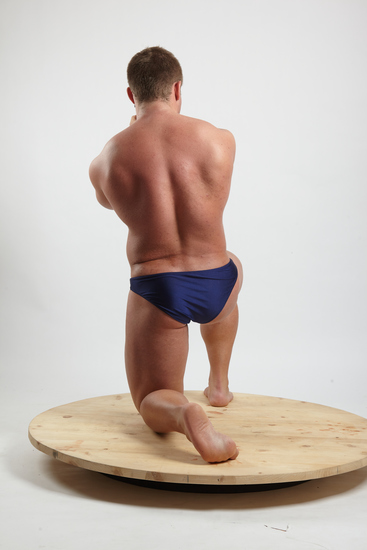 Man Adult Muscular White Fighting with gun Kneeling poses Underwear